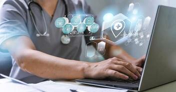 Doctor working on credentialing with laptop