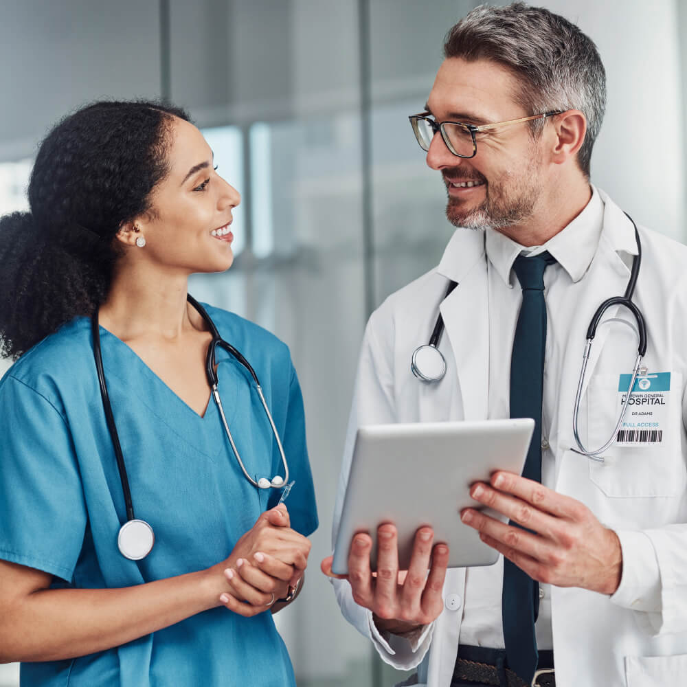 female-male-doctors-collaborating-ipad